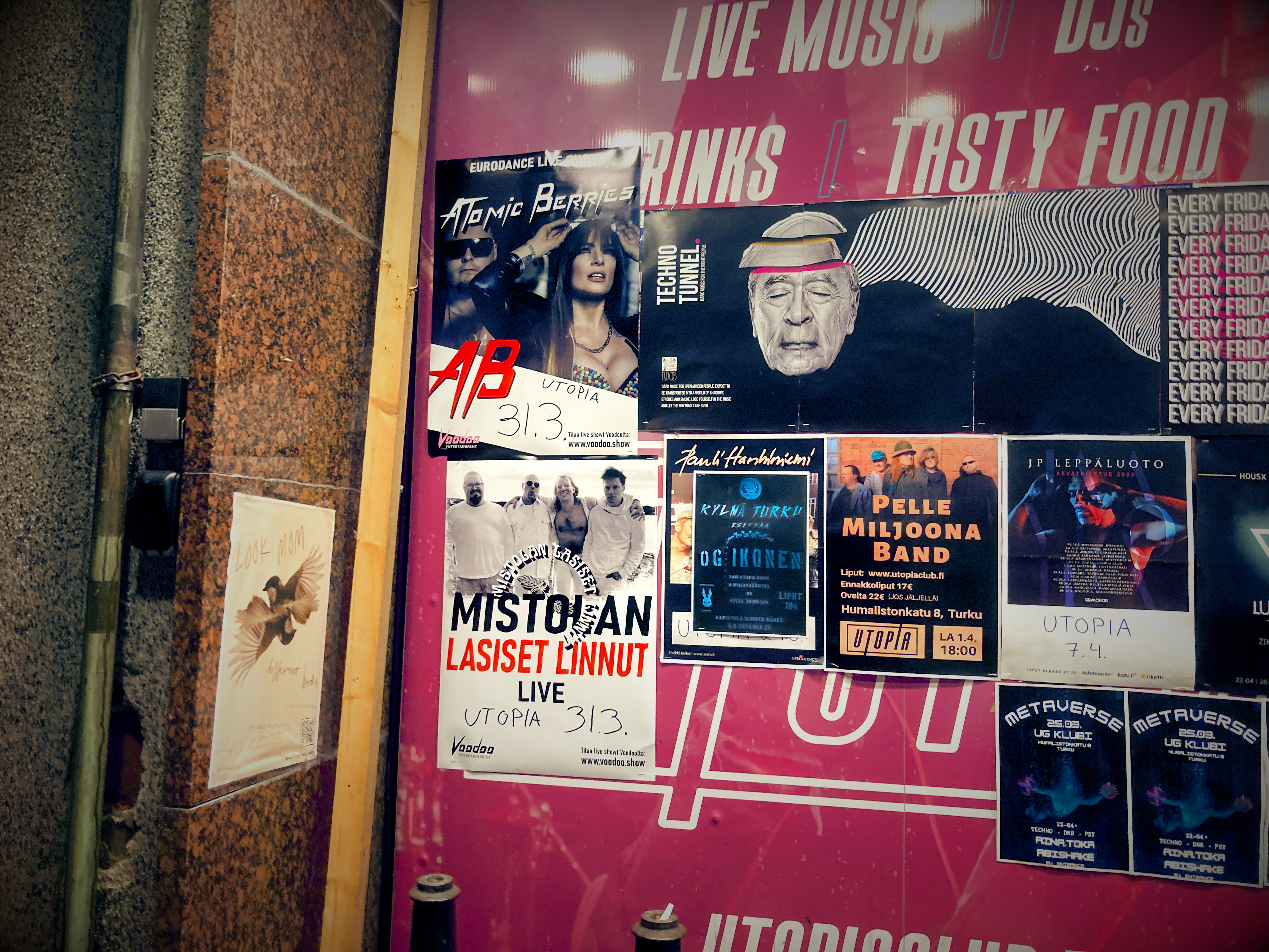 A wall at Utopia Nightclub featuring the Atomic gig poster among many others.