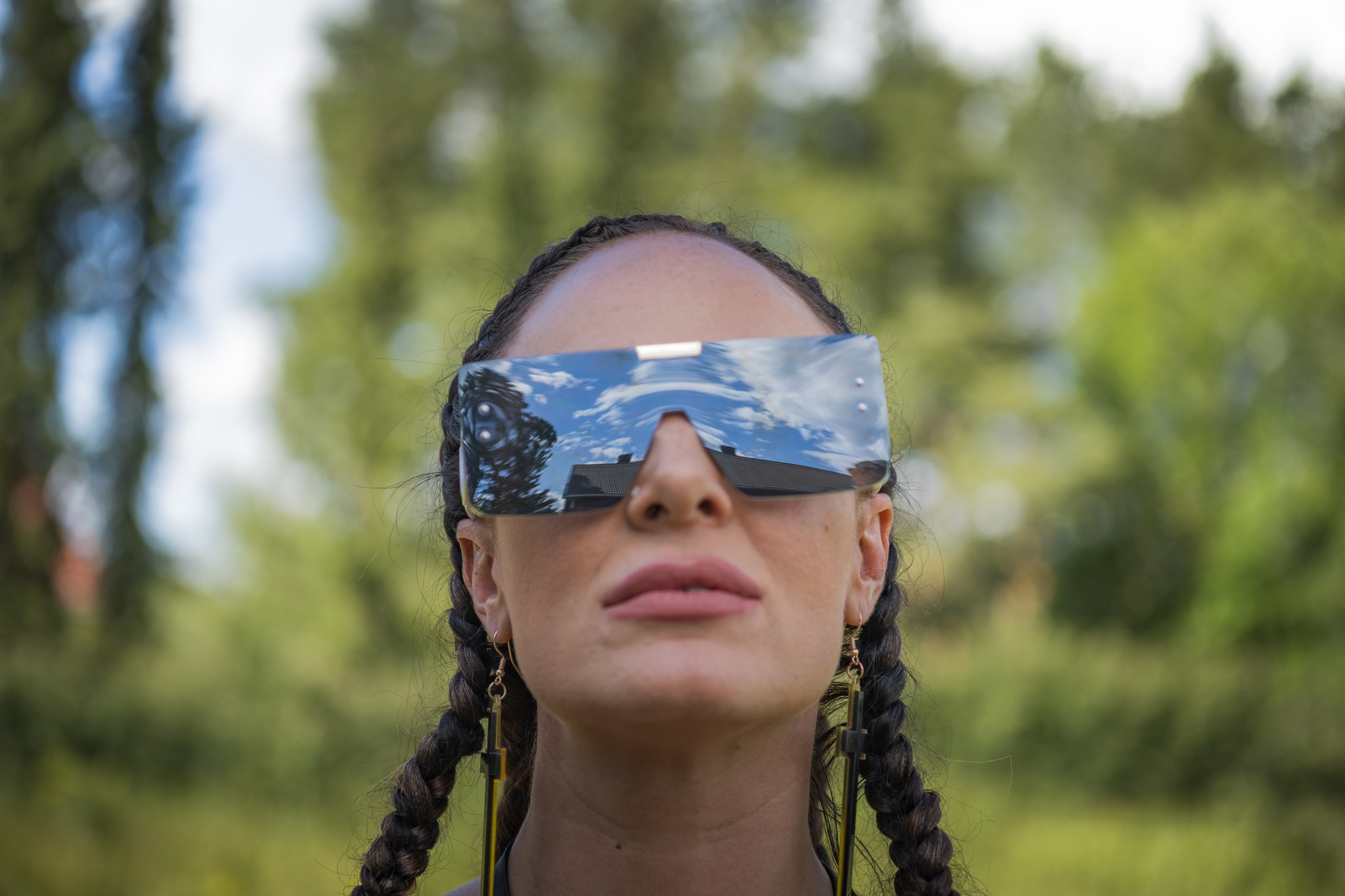 Close-up portrait of Tanja outdoors wearing oversized sunglasses.
