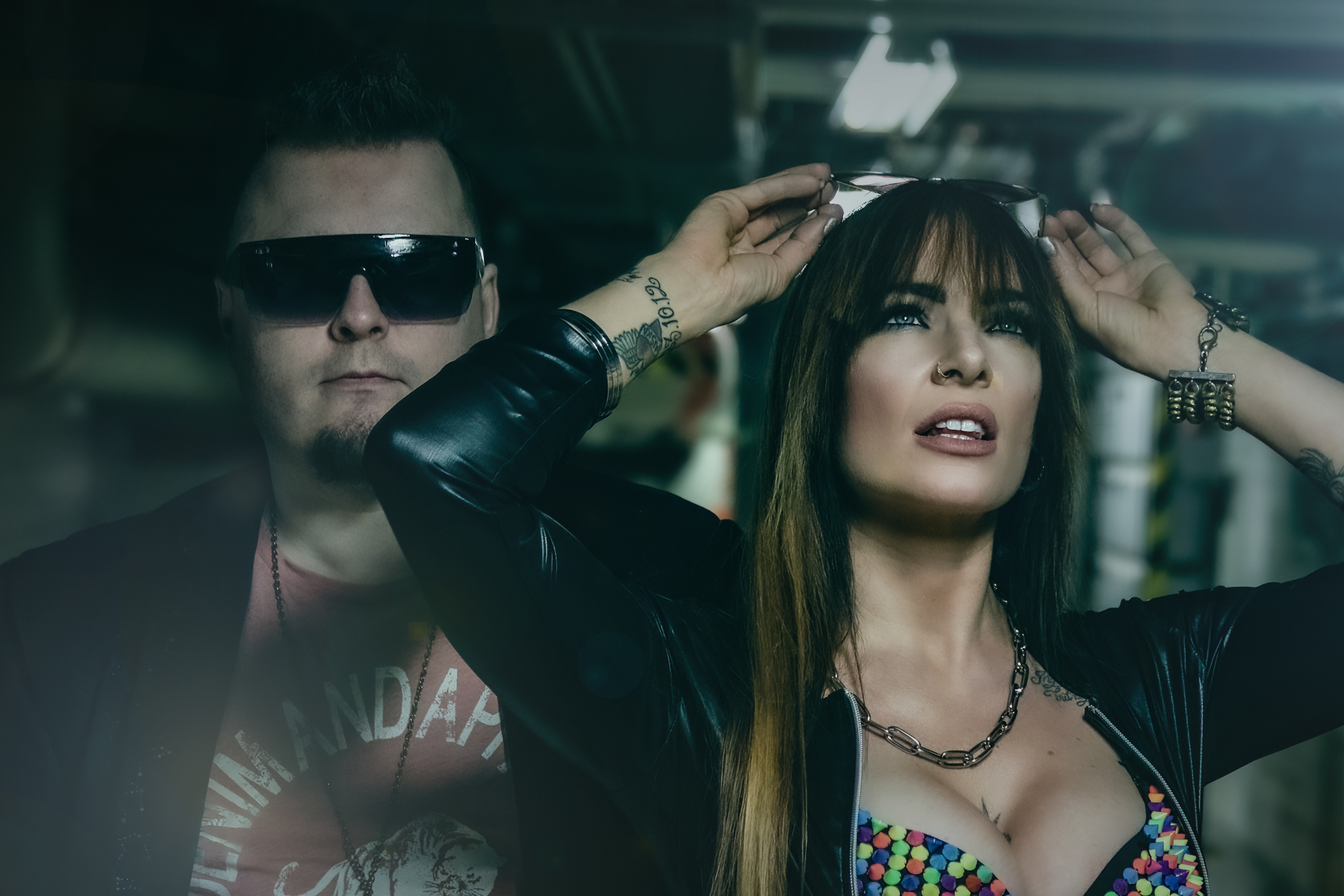 Promo photo of broad-shouldered Mike Midas and Tanita wearing a candy-themed top.